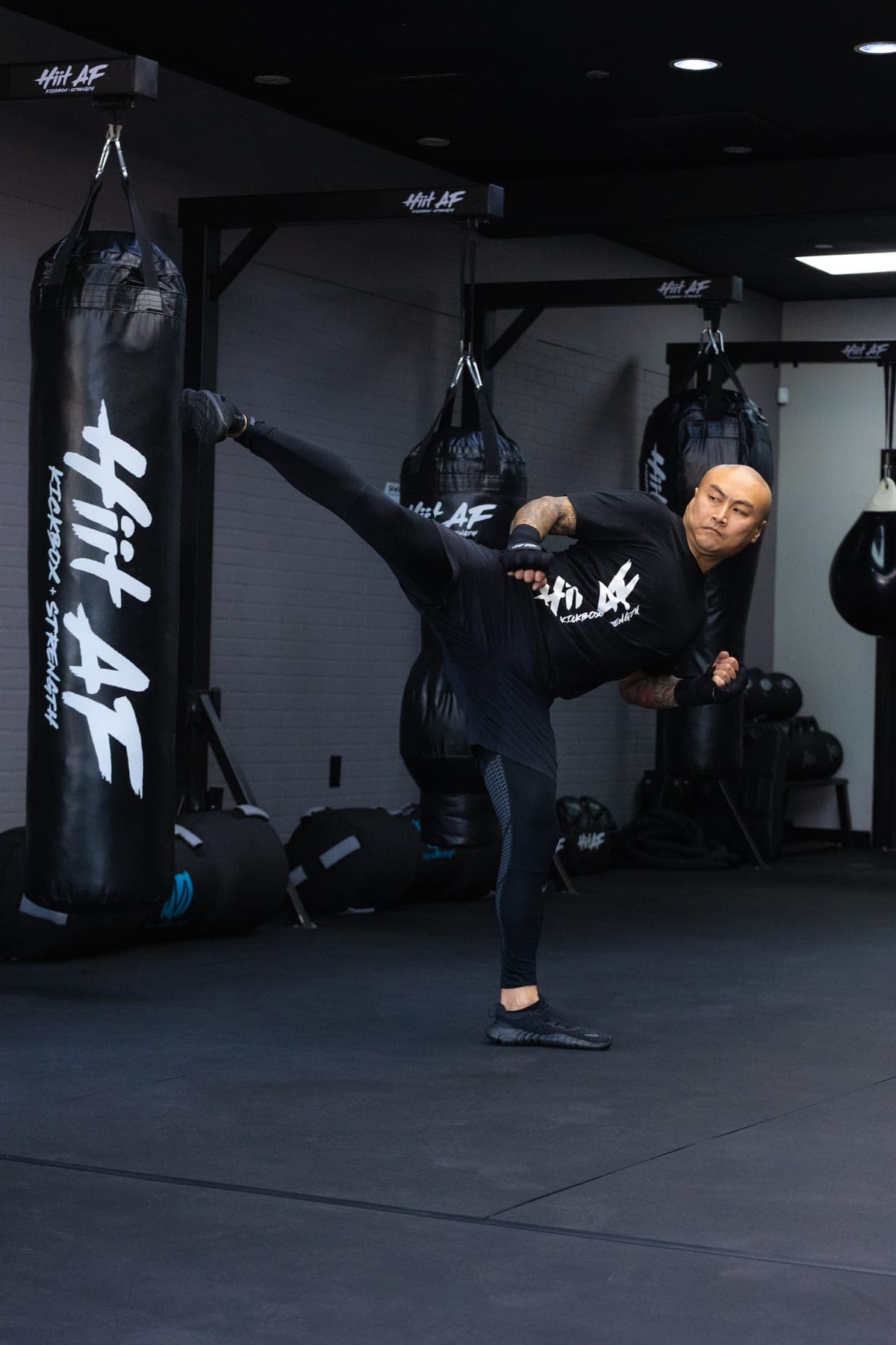 Steven Liu performing a high kick at HIIT AF